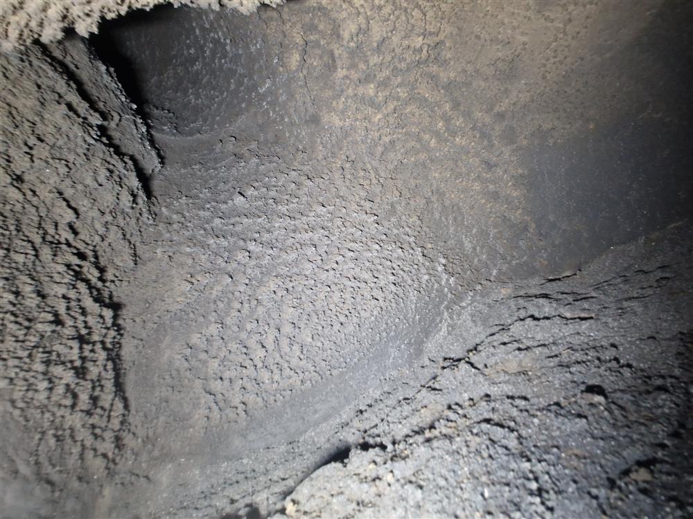 A chimney chamber with every surface caked in soot