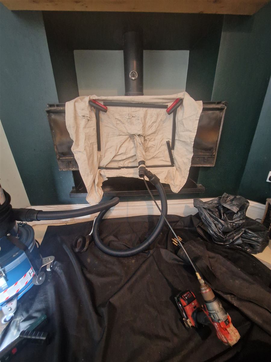 Stove sealed with dust sheet and extraction hose