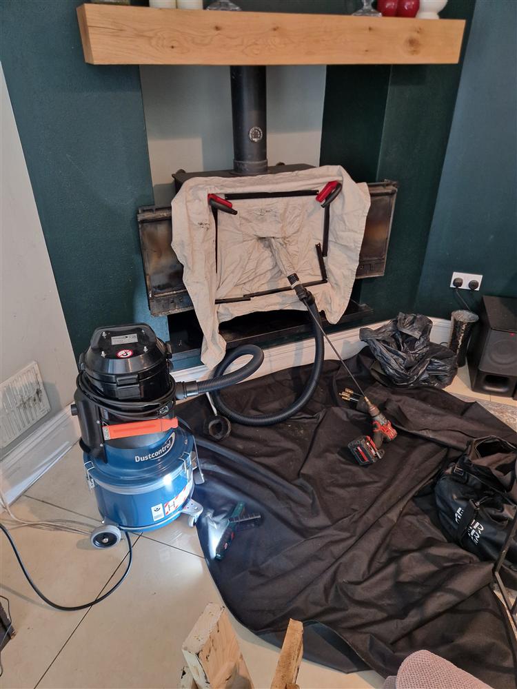 Stove sealed with a cloth, power sweeping rods and H-class vacuum ready on dust sheets